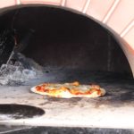 baking pizza in Wood Fire Pizza Oven