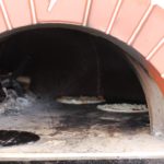 baking pizza in Wood Fire Pizza Oven